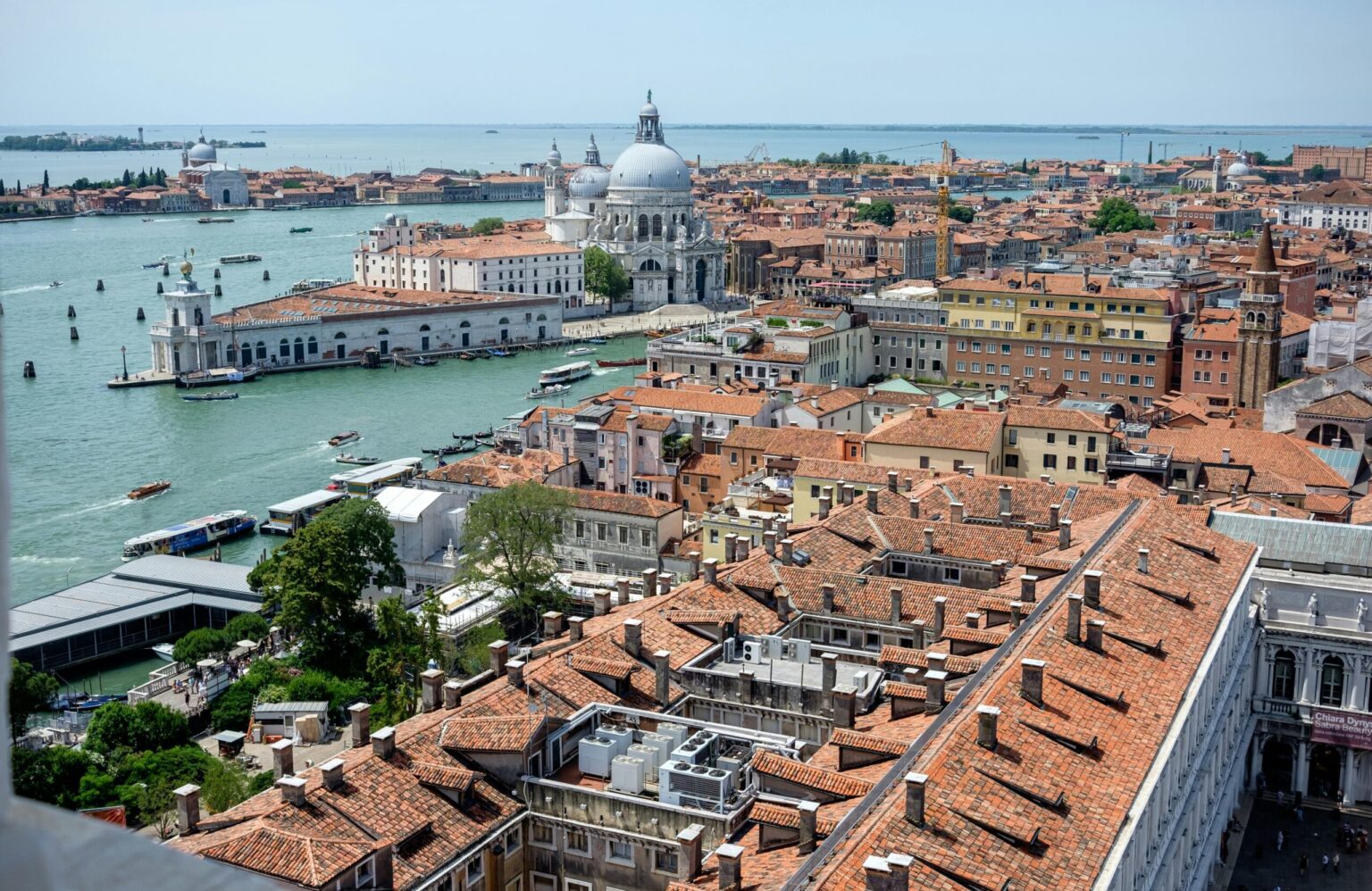 Stunning aerial view of Venice's iconic rooftops and waterways, showcasing historic Italian architecture.